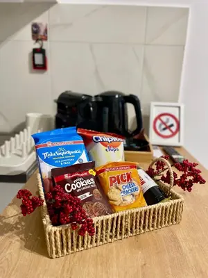 a basket of food and snacks on a table at Zografou City Studio in Athens