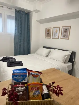 a bedroom with a bed and a basket of food on a table at Zografou City Studio in Athens