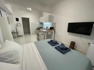 a bedroom with a bed with blue towels on it at Zografou City Studio in Athens