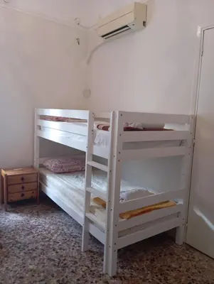 a bedroom with two bunk beds and a closet at Κρεβάτια σε κοιτώνα 5' from metro in Athens