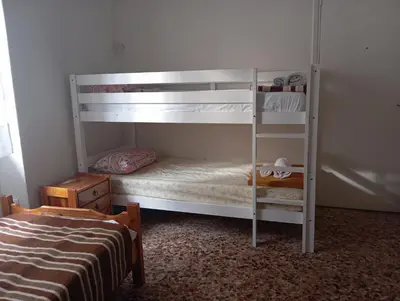 a bedroom with two bunk beds and a bed at Κρεβάτια σε κοιτώνα 5' from metro in Athens