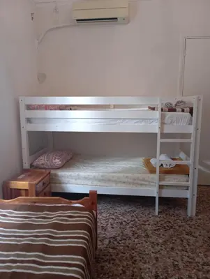 a bedroom with two bunk beds and a bed at Κρεβάτια σε κοιτώνα 5' from metro in Athens