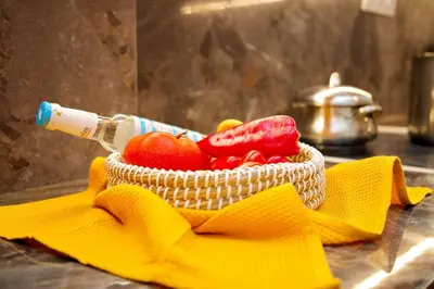 a basket of vegetables sitting on a counter with a bottle at Aroura Home 2BR Neos Kosmos in Athens