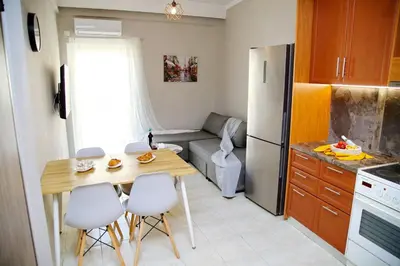 a small kitchen with a table and chairs in a room at Aroura Home 2BR Neos Kosmos in Athens