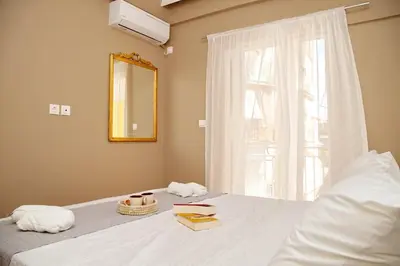 a bedroom with a bed with a window and a mirror at Aroura Home 2BR Neos Kosmos in Athens