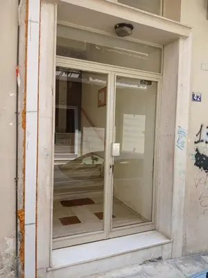 a glass door of a building with a reflection in it at Aroura Home 2BR Neos Kosmos in Athens