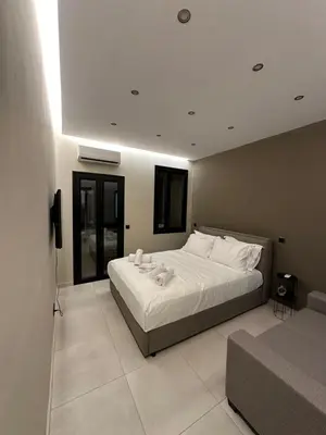 a bedroom with a large white bed and a couch at Dionysos Suites in Athens