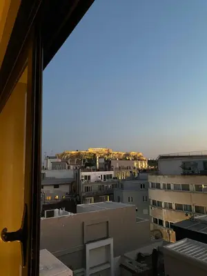 a view of a city from a window at Dionysos Suites in Athens