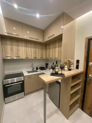a kitchen with wooden cabinets and a wooden counter top at Dionysos Suites in Athens
