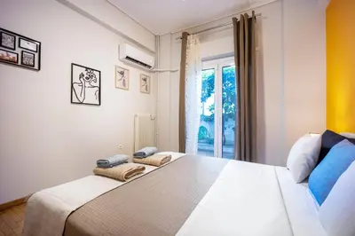 a bedroom with a large bed and a window at Spacious Garden apt in Athens
