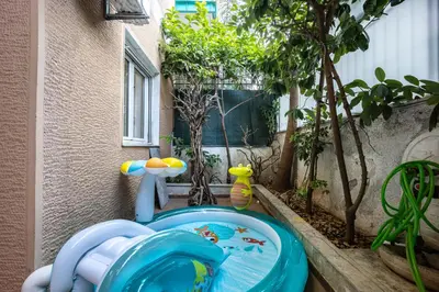 a childs toy toilet in a garden with trees at Spacious Garden apt in Athens