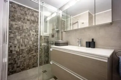 a bathroom with a sink and a shower at Spacious Garden apt in Athens