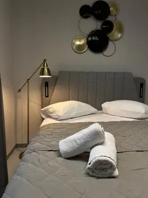 a bedroom with a bed with a white towel on it at Aura Suite by Zeussuites in Athens