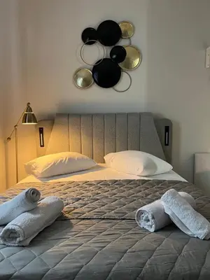 a bedroom with a large bed with towels on it at Aura Suite by Zeussuites in Athens