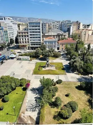 a park with a statue in the middle of a city at Aura Suite by Zeussuites in Athens