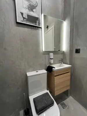 a bathroom with a toilet and a sink and a mirror at Iris Suite by Zeussuites in Athens