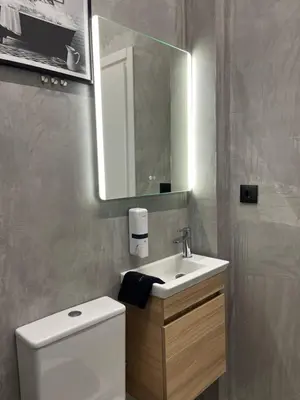 a bathroom with a toilet and a sink and a mirror at Iris Suite by Zeussuites in Athens