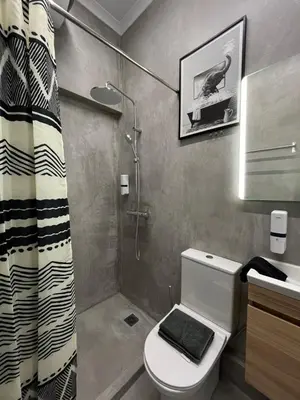 a bathroom with a toilet and a shower at Iris Suite by Zeussuites in Athens