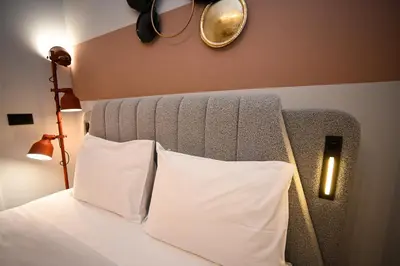 a bedroom with a bed with two white pillows at Iris Suite by Zeussuites in Athens