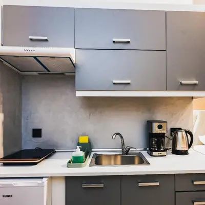 a kitchen with a sink and a microwave at Iris Suite by Zeussuites in Athens