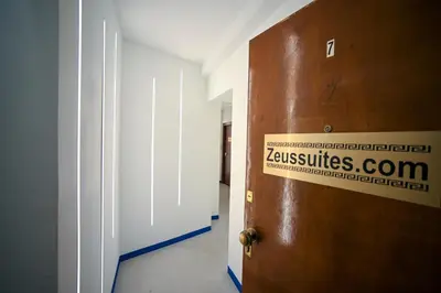 a door with a sign on it in a room at Syntagma Plaka Suite by Zeussuites in Athens