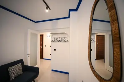a living room with a mirror and a chair at Syntagma Plaka Suite by Zeussuites in Athens