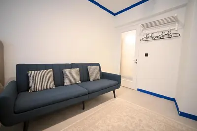 a blue couch in a room with a door at Syntagma Plaka Suite by Zeussuites in Athens