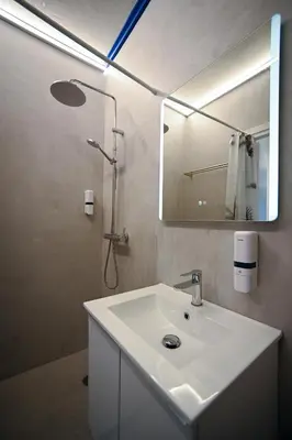 a white bathroom with a sink and a mirror at Syntagma Plaka Suite by Zeussuites in Athens