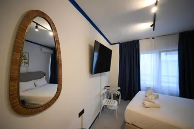 a bedroom with a mirror and a bed and a chair at Syntagma Plaka Suite by Zeussuites in Athens