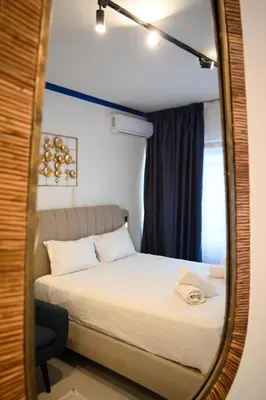 a bedroom with a bed in a mirror at Syntagma Plaka Suite by Zeussuites in Athens