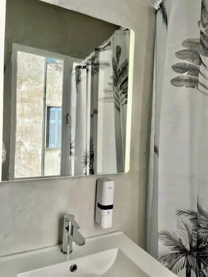 a bathroom with a sink and a mirror at Plaka Central Suite by Zeussuites in Athens