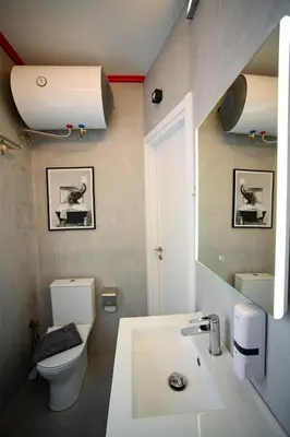 a bathroom with a sink and a toilet and a mirror at Plaka Central Suite by Zeussuites in Athens
