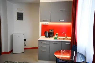 a small kitchen with a sink and a counter at Plaka Central Suite by Zeussuites in Athens