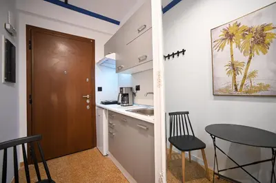 a kitchen with a door and a table and chairs at Monastiraki Suite by Zeussuites in Athens