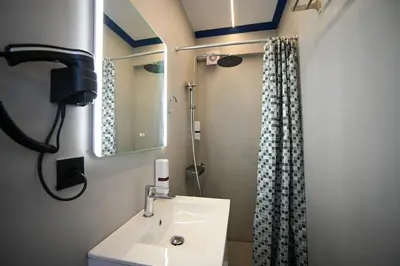 a bathroom with a sink and a shower at Ermou Suite by Zeussuites in Athens