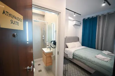 a small room with a bed and a bathroom at Athinaidos Suite by Zeussuites in Athens