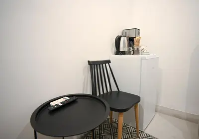 a black table and a chair and a coffee maker at Athinaidos Suite by Zeussuites in Athens