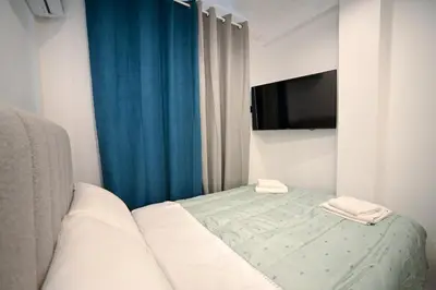 a room with a bed with a television and a bed sidx sidx sidx at Athinaidos Suite by Zeussuites in Athens