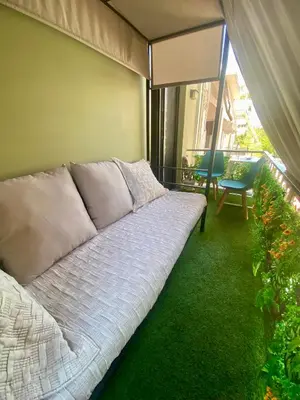 a couch in a room with a balcony at Sophia Urban lux in Athens