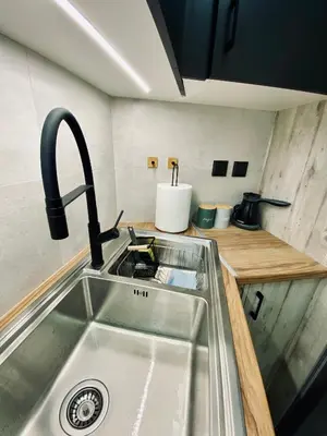 a kitchen sink with a faucet on top of it at Sophia Urban lux in Athens