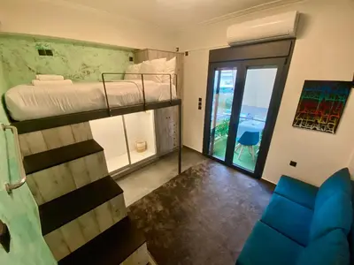 a room with a bunk bed and a couch at Sophia Urban lux in Athens