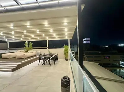 a balcony with a table and chairs on a building at BlueMotion - CityView in Piraeus