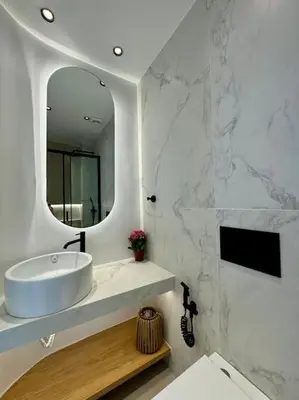 a white bathroom with a sink and a mirror at BlueMotion - CityView in Piraeus