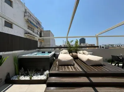 a rooftop patio with a hot tub on a building at BlueMotion - CityView in Piraeus