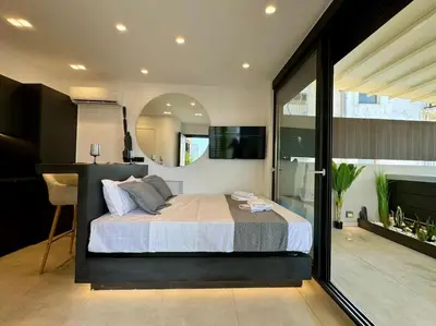 a bedroom with a bed and a large window at BlueMotion - CityView in Piraeus