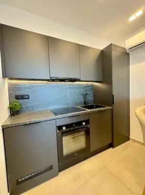 a kitchen with stainless steel appliances and a sink at BlueMotion - CityView in Piraeus