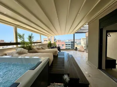 a living room with a hot tub and a couch at BlueMotion - CityView in Piraeus
