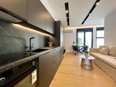 a kitchen and living room with a couch and a table at BlueMotion - PortSuite 4B in Piraeus