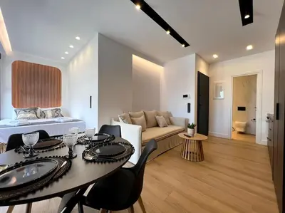 a living room with a bed and a table and chairs at BlueMotion - PortSuite 4B in Piraeus