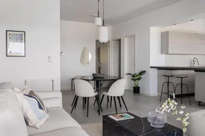 a living room with a couch and a table at Alimos 2BR Apartment with Splendid Sea View by UPSTREET in Athens